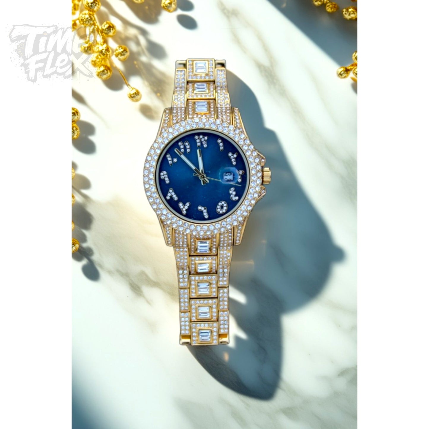 Gold-tone Men's women's watch with diamond-studded bezel, featuring a blue dial with crystal-encrusted Roman numerals and a date display. The watch has a glamorous, sparkling band with rectangular stones, offering a luxurious and stylish look.
