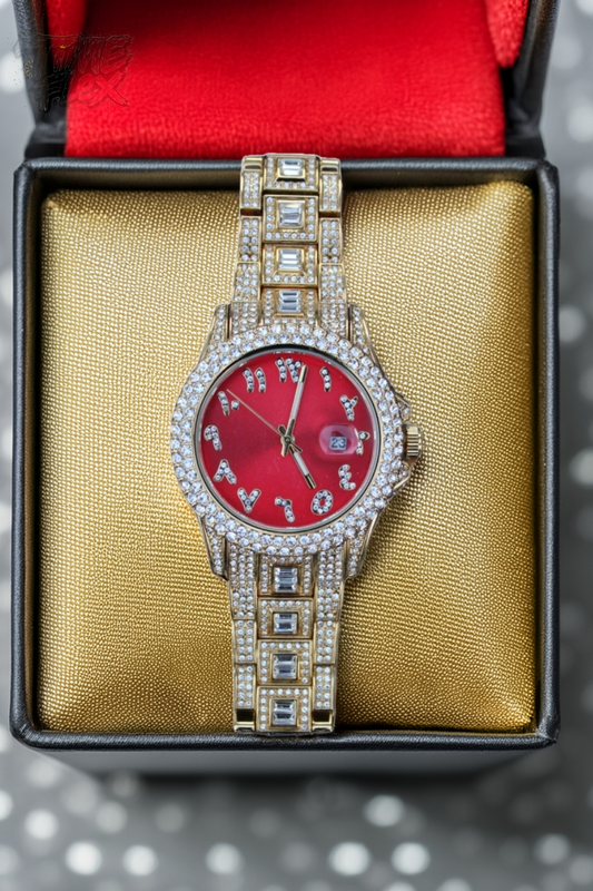 Gold-tone unisex watch with a red dial, crystal-encrusted bezel, and rectangular stones on the band. The watch features sparkling Roman numeral markers and a date display, offering a luxurious and eye-catching design.