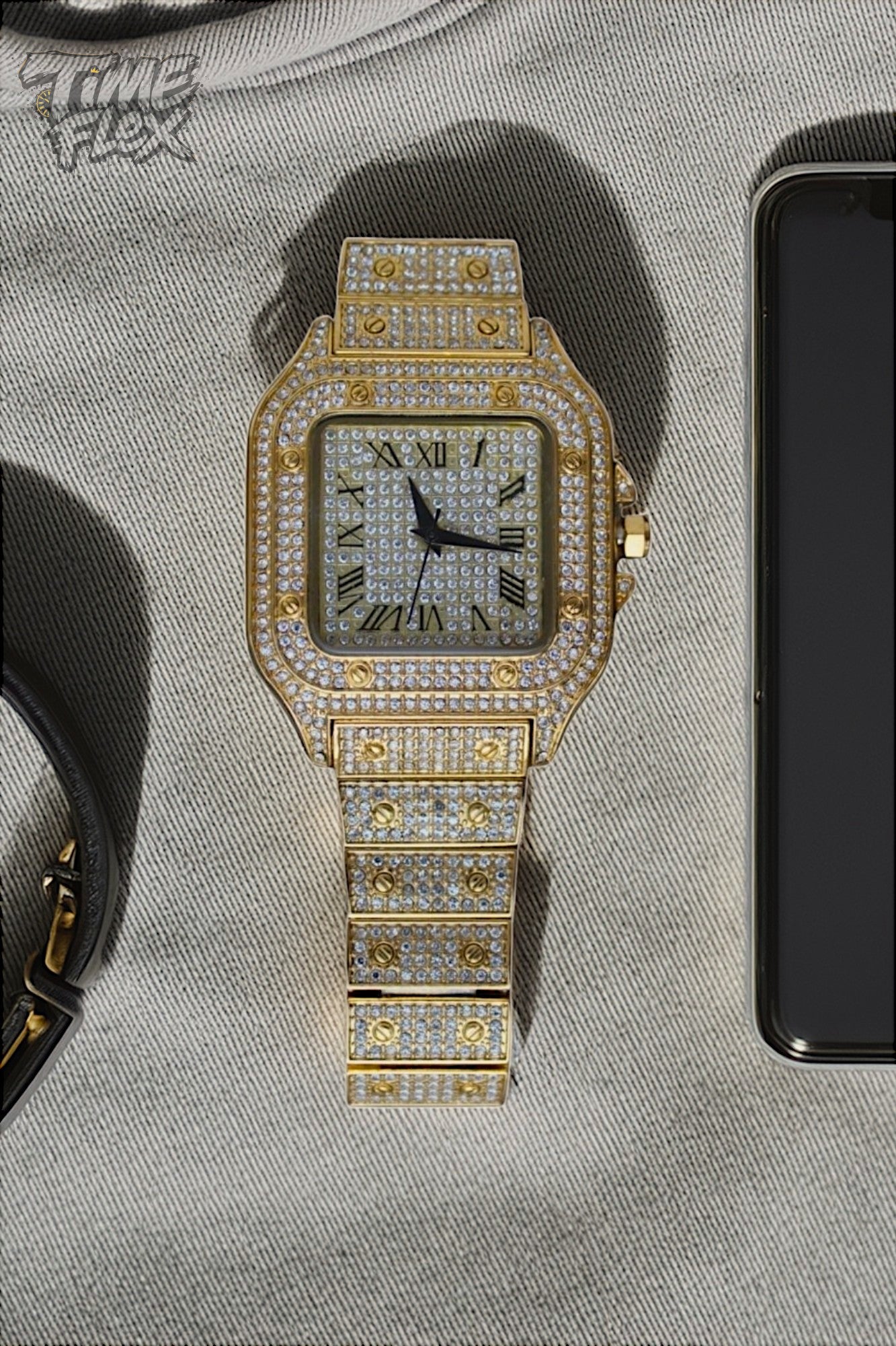 Gold-tone unisex watch with a red dial, crystal-encrusted bezel, and rectangular stones on the band. The watch features sparkling Roman numeral markers and a date display, offering a luxurious and eye-catching design.