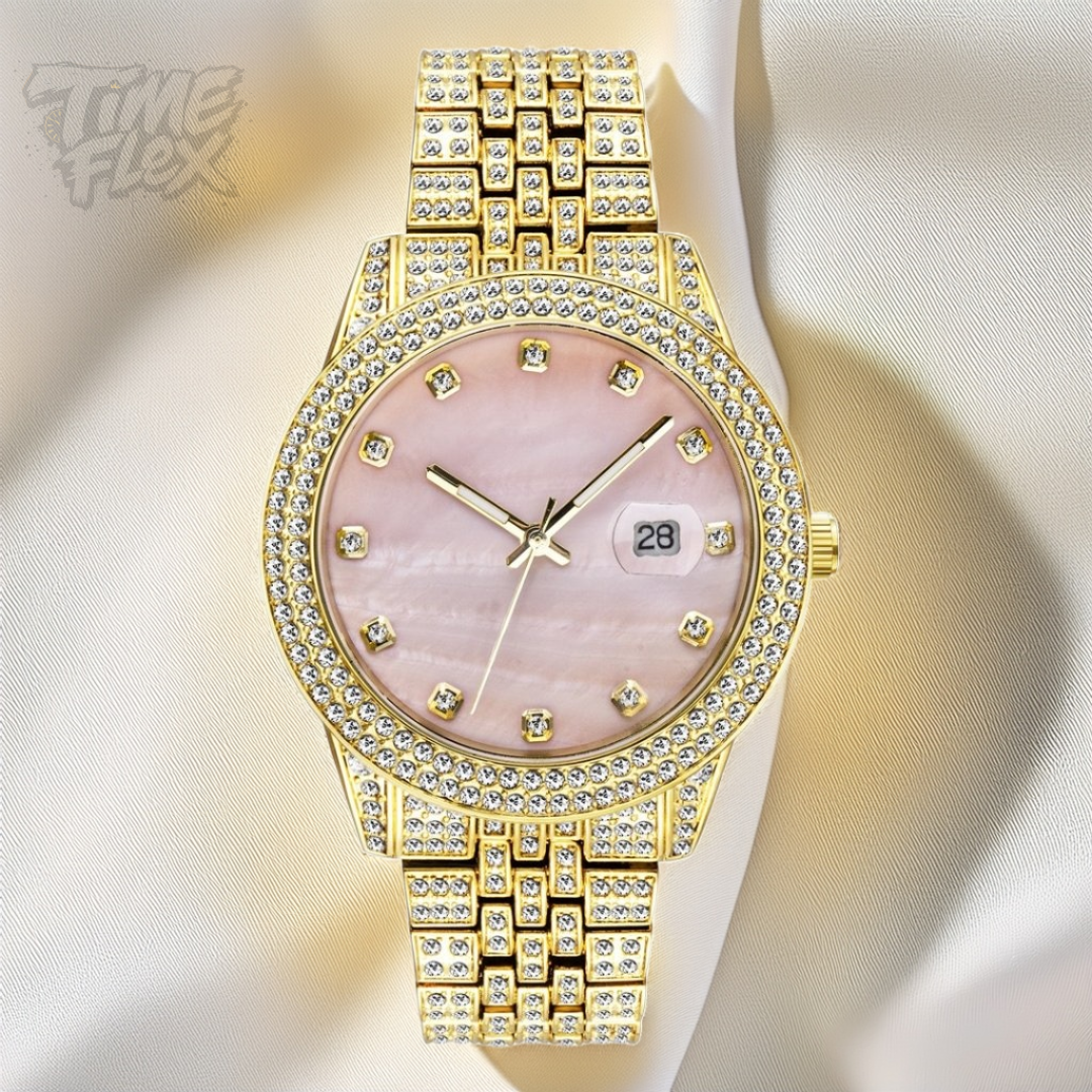 Gold-tone women's watch with a diamond-studded bezel, pink mother-of-pearl dial, and date display at the 3 o'clock position. The watch features a shimmering, crystal-encrusted gold band for a glamorous and luxurious look.