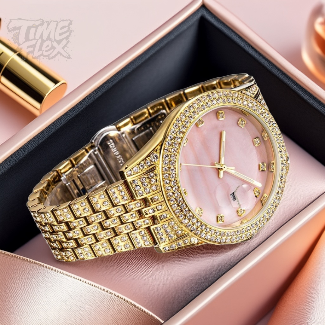 Gold-tone women's watch with a diamond-studded bezel, pink mother-of-pearl dial, and date display at the 3 o'clock position. The watch features a shimmering, crystal-encrusted gold band for a glamorous and luxurious look.