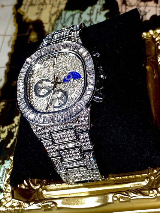 Silver iced-out chronograph watch with baguette bezel and moon phase dial – luxury diamond timepiece