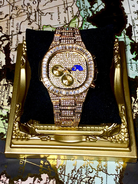 Gold-tone unisex watch with a diamond-studded dial and bezel. The watch features dual sub-dials, a moonphase display, and a sparkling crystal-encrusted band, offering a luxurious and high-end look.