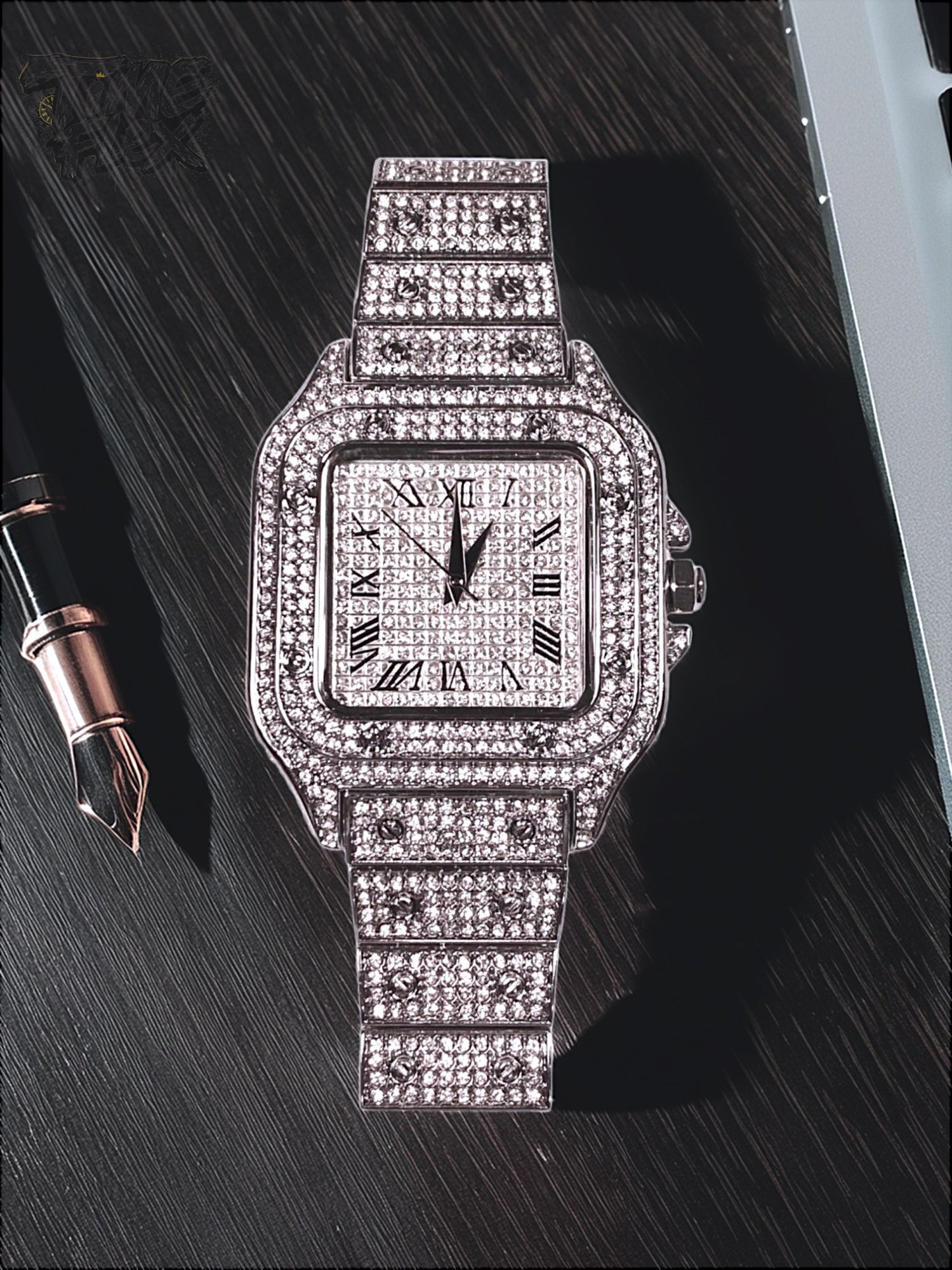 Silver-tone unisex watch with a square dial, crystal-encrusted bezel, and sparkling band. The watch features Roman numeral markers and a luxurious, diamond-studded design, offering a sleek and elegant look.