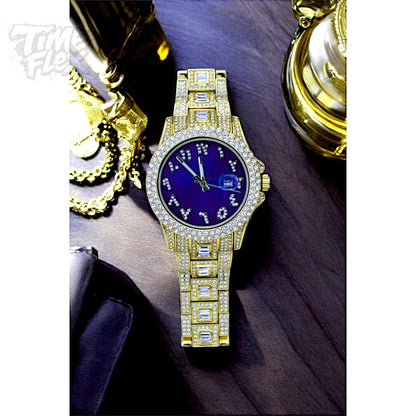 Gold-tone Men's women's watch with diamond-studded bezel, featuring a blue dial with crystal-encrusted Roman numerals and a date display. The watch has a glamorous, sparkling band with rectangular stones, offering a luxurious and stylish look.