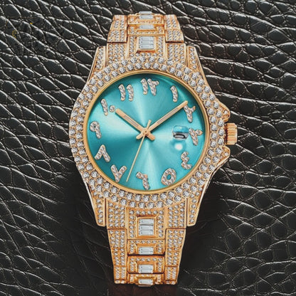 Gold-tone Men's women's watch with diamond-studded bezel, featuring a blue dial with crystal-encrusted Roman numerals and a date display. The watch has a glamorous, sparkling band with rectangular stones, offering a luxurious and stylish look.