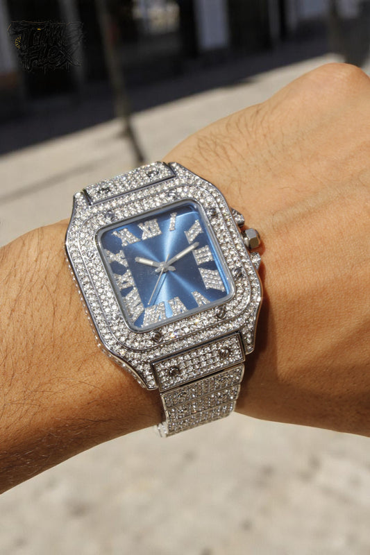 Close-up of luxury square watch with blue sunburst face and diamond bezel