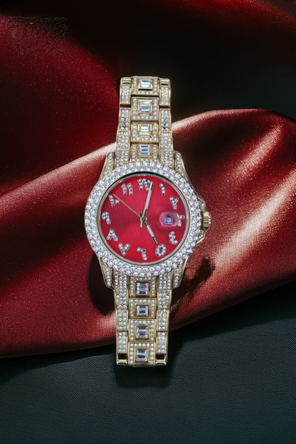 Gold-tone unisex watch with a red dial, crystal-encrusted bezel, and rectangular stones on the band. The watch features sparkling Roman numeral markers and a date display, offering a luxurious and eye-catching design.