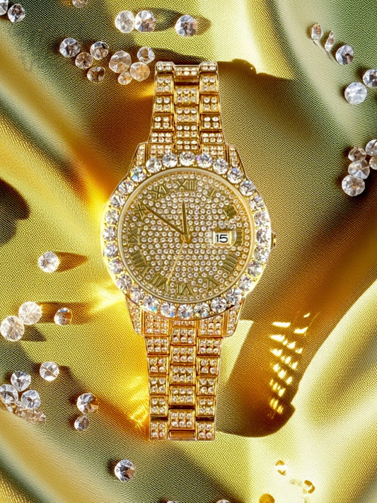 Gold-tone women's and men's watch with a diamond-studded bezel and a sparkling crystal-encrusted band. The watch features a textured gold dial, Roman numeral markers, and a date display at the 3 o'clock position, offering a luxurious and elegant look.