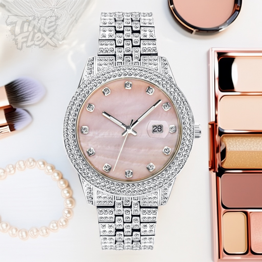 Silver-tone women's watch with a diamond-studded bezel, pink mother-of-pearl dial, and date display at the 3 o'clock position. The watch features a shiny, crystal-encrusted band for a luxurious finish.