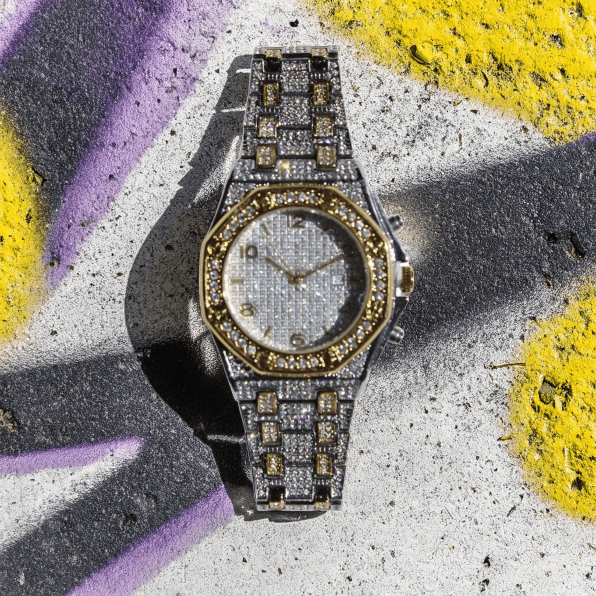 Iced-out two-tone watch with gold hex bezel, silver pavé dial, and chronograph details – urban luxury timepiece