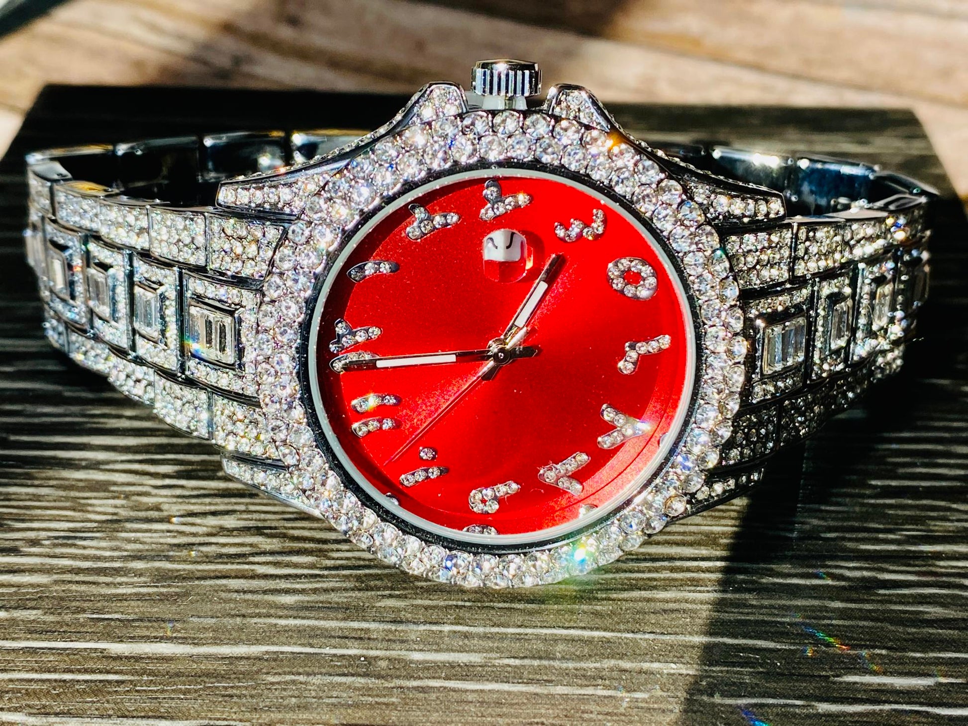 Silver iced-out watch with scarlet red dial, crystal markers, and baguette bracelet – luxury streetwear timepiece