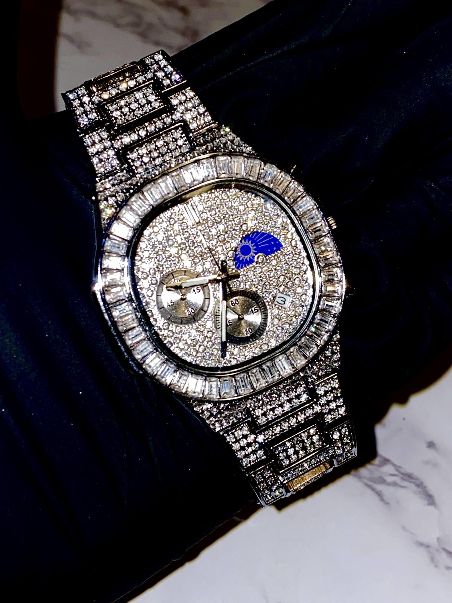 Silver iced-out chronograph watch with baguette bezel and moon phase dial – luxury diamond timepiece