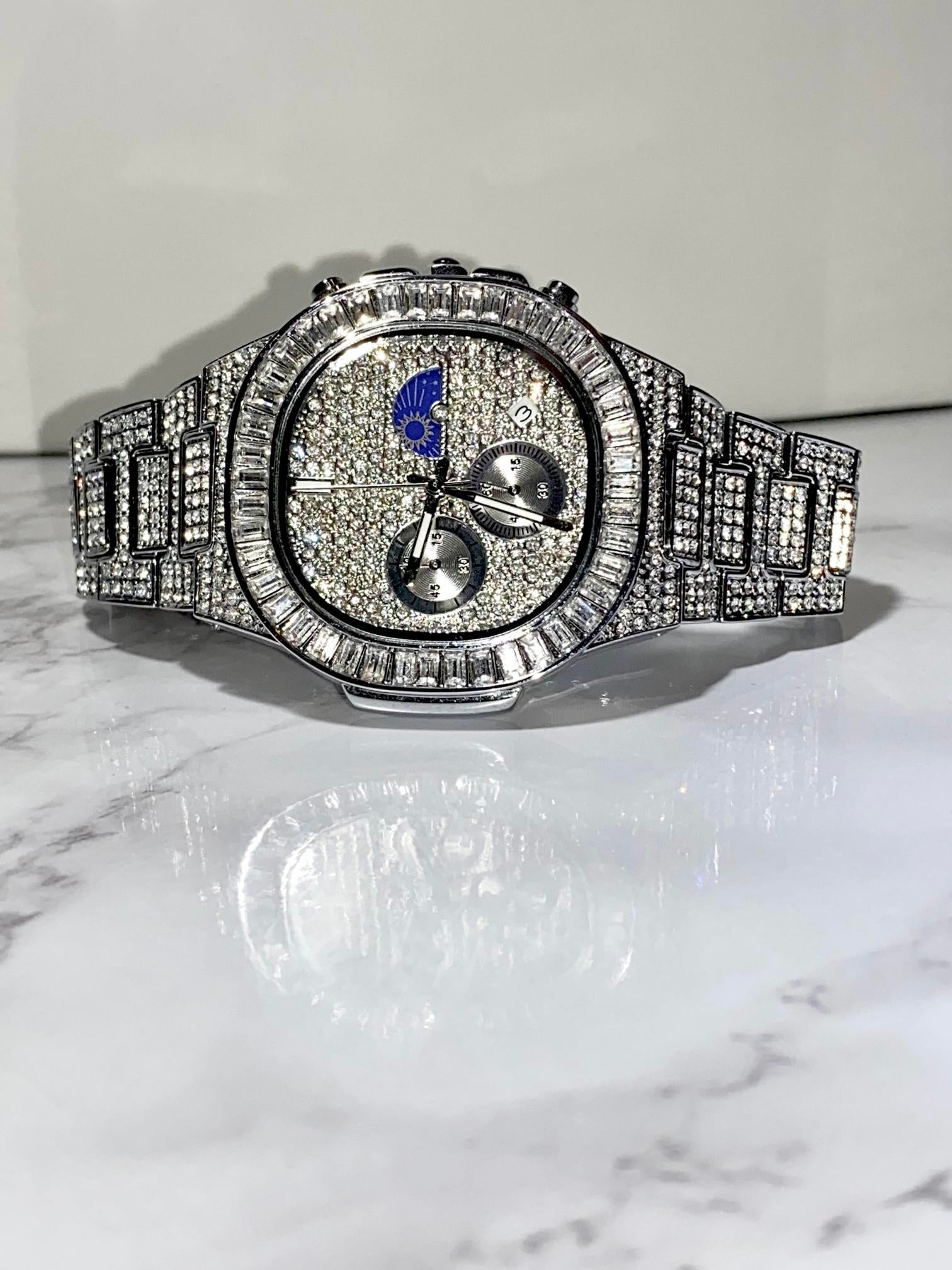 Silver iced-out chronograph watch with baguette bezel and moon phase dial – luxury diamond timepiece