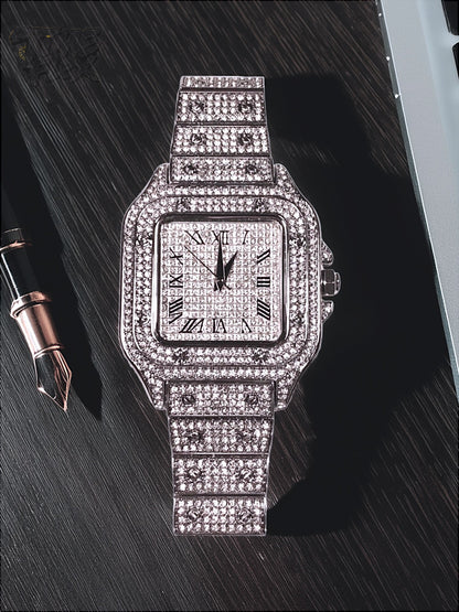 Silver-tone unisex watch with a square dial, crystal-encrusted bezel, and sparkling band. The watch features Roman numeral markers and a luxurious, diamond-studded design, offering a sleek and elegant look.