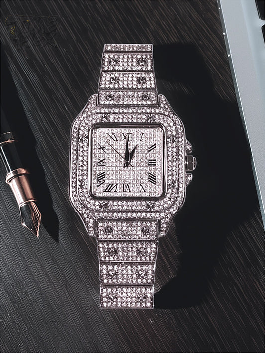 Silver-tone unisex watch with a square dial, crystal-encrusted bezel, and sparkling band. The watch features Roman numeral markers and a luxurious, diamond-studded design, offering a sleek and elegant look.