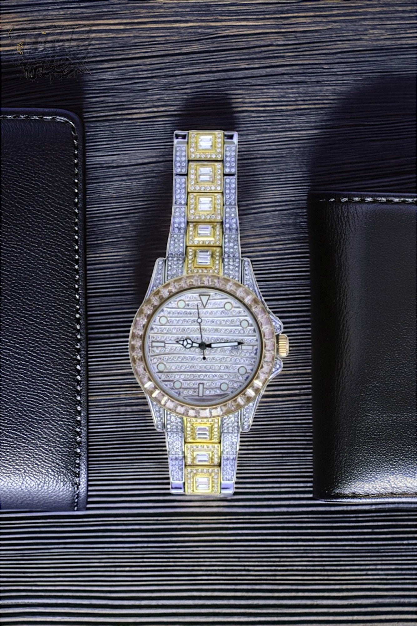 Silver and gold men's women's watch with a diamond-studded bezel and rectangular stone accents on the band. The watch features a sleek white dial with black hands and a date display.