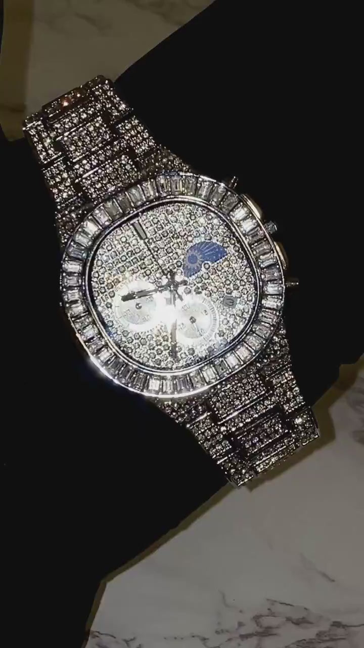 Silver iced-out chronograph watch with baguette bezel and moon phase dial – luxury diamond timepiece