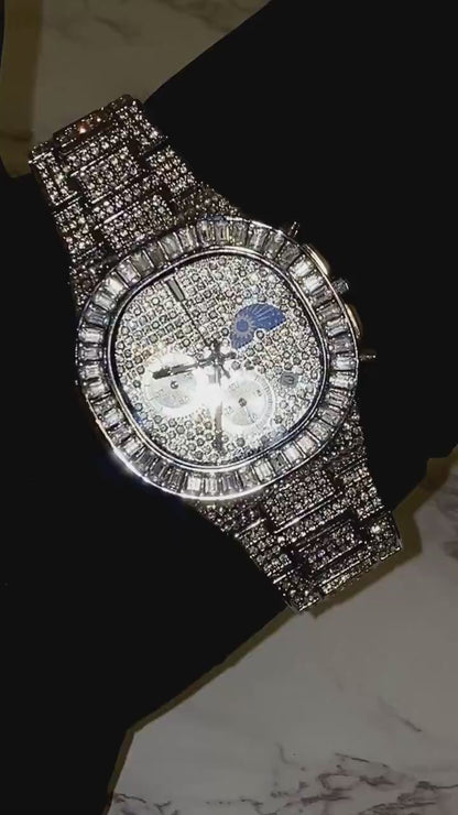 Silver iced-out chronograph watch with baguette bezel and moon phase dial – luxury diamond timepiece