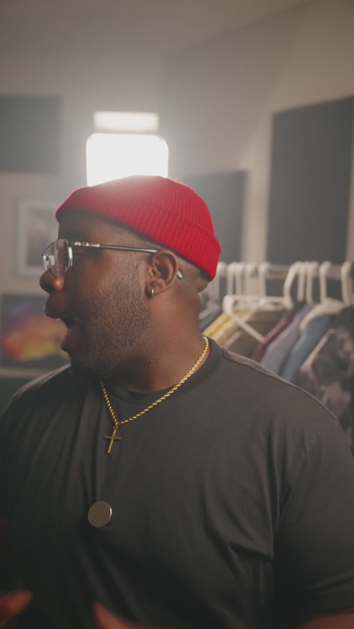 Load video: Unboxing review video showing a close-up of a person wearing a black shirt and gold cross necklace, sharing their first impressions of a luxury watch.